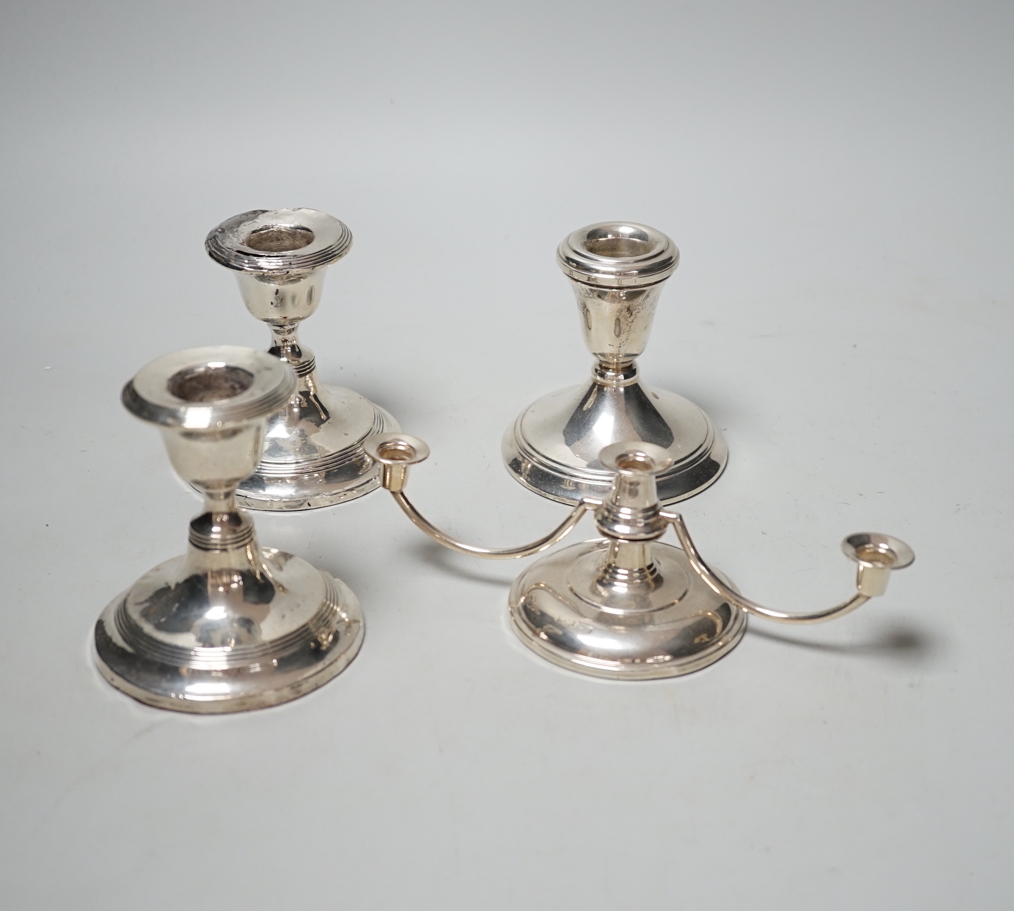 A pair of silver mounted dwarf candlesticks (a.f.), one other dwarf candlestick and a modern silver dwarf candelabrum.